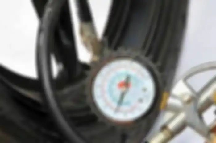 Ilustrasi mengukur tekanan ban motor.