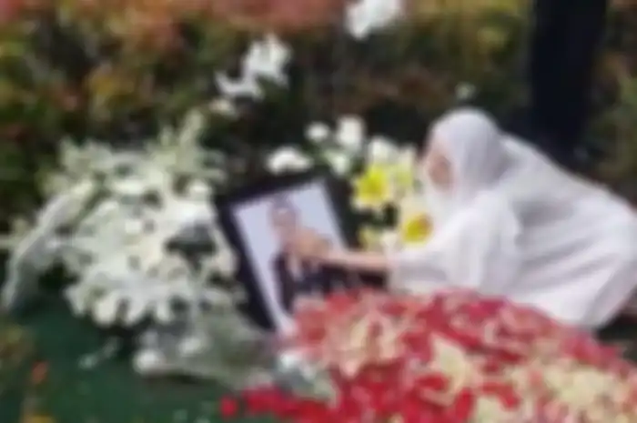 Bunga Citra Lestari mengusap foto almarhum suaminya Ashraf Sinclair yang dimakamkan di San Diego Hills Memorial Park, Karawang, Selasa (18/2/2020). (Tribunnews/Dany Permana)