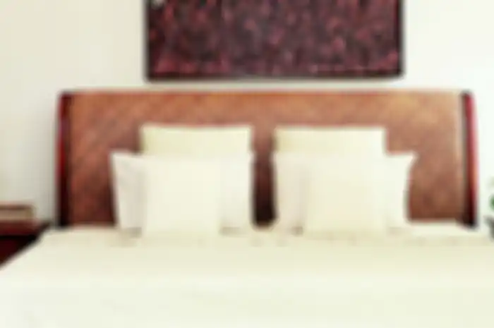 Aksen anyaman pada headboard tempat tidur modern.