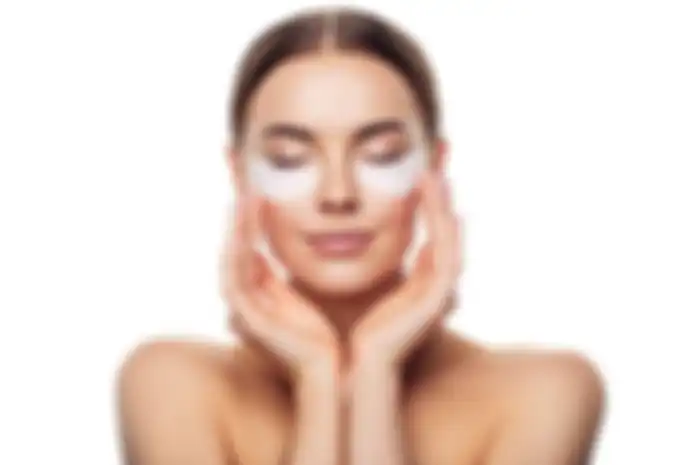Woman with eye patches under her eyes