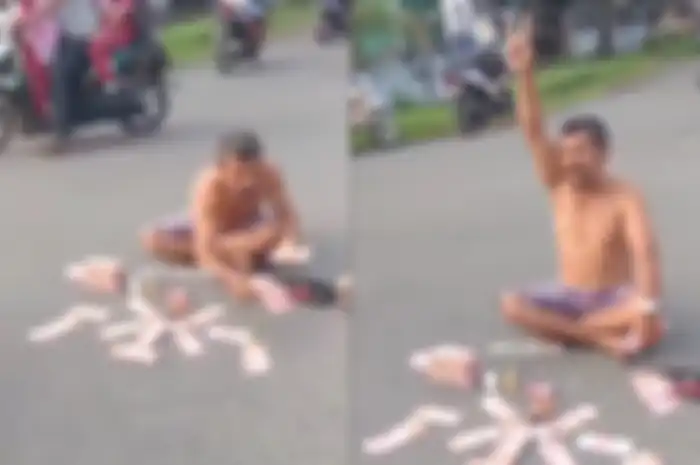 Pria tumpuk uang di tengah jalan dan tantang adu kekayaan.