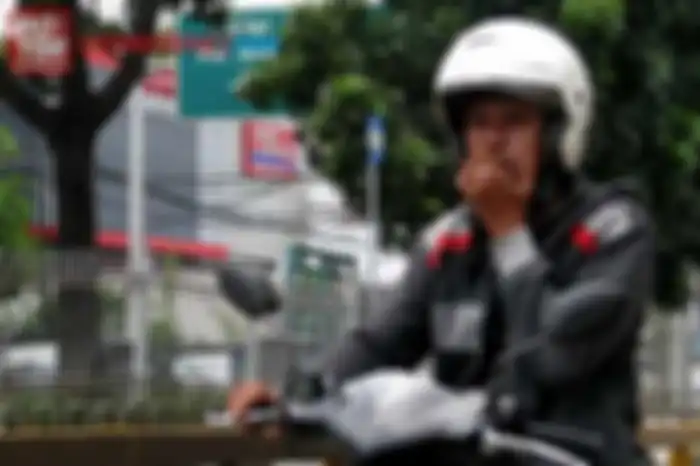 Ilustrasi naik motor sambil merokok.