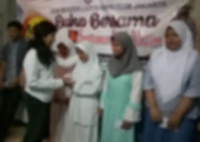 Pendiri IBLBC, Inuk Blazer memberikan santunan kepada anak yatim piatu.