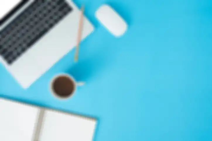 Minimal work space - Creative flat lay photo of workspace desk. Top view office desk with laptop, notebooks and coffee cup on blue color background. Top view with copy space, flat lay photography.