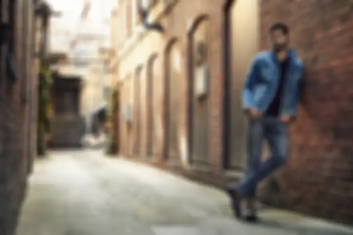 Man standing in street wearing denim, portrait