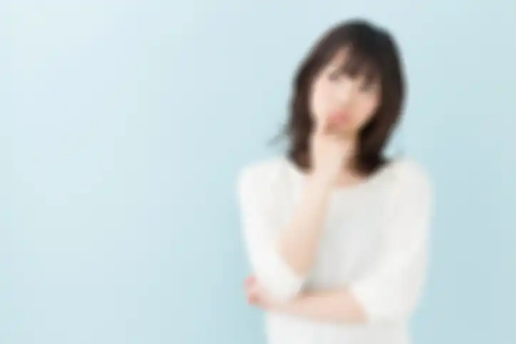 portrait of attractive asian woman isolated on blue background