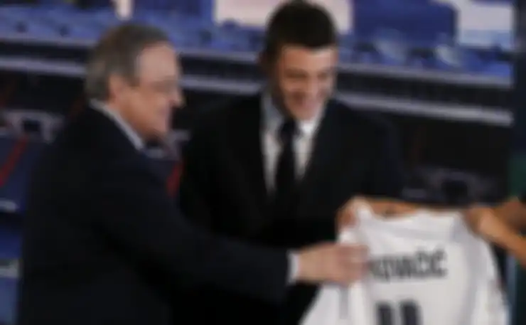 Croatian midfielder Mateo Kovacic (R) poses next to Real Madrids president Florentino Perez, during