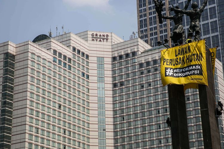 Aktivis dari Greenpeace memanjat Monumen Selamat Datang atau patung Bundaran Hotel Indonesia, Jakarta Pusat, Rabu (23/10/2019). 