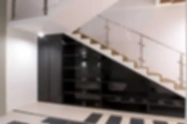 Lemari penyimpanan di bawah tangga di Muara Bungo Residence, karya Fine Team Studio 