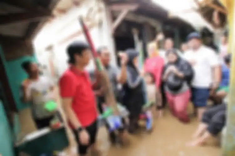 tim Indosat membagikan bantuan ke korban banjir