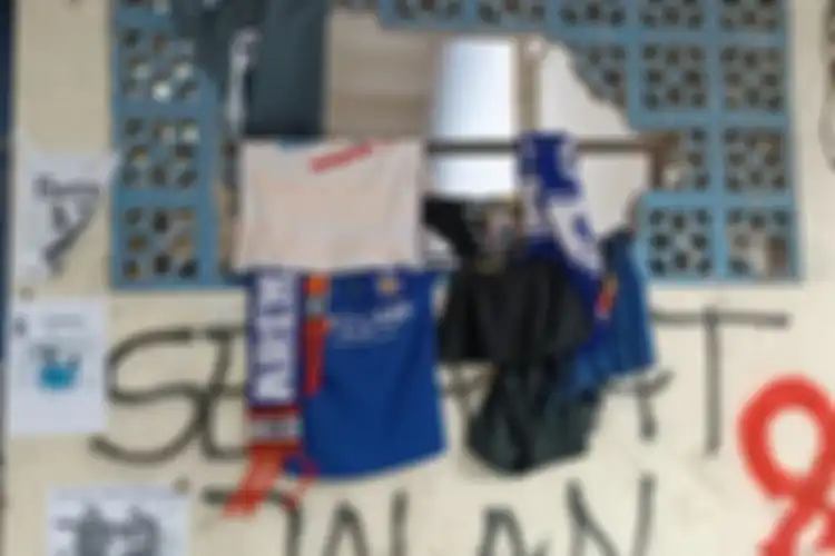 Kaos Aremania digantung di dinding ventilasi pintu keluar tribun 13 Stadion Kanjuruhan