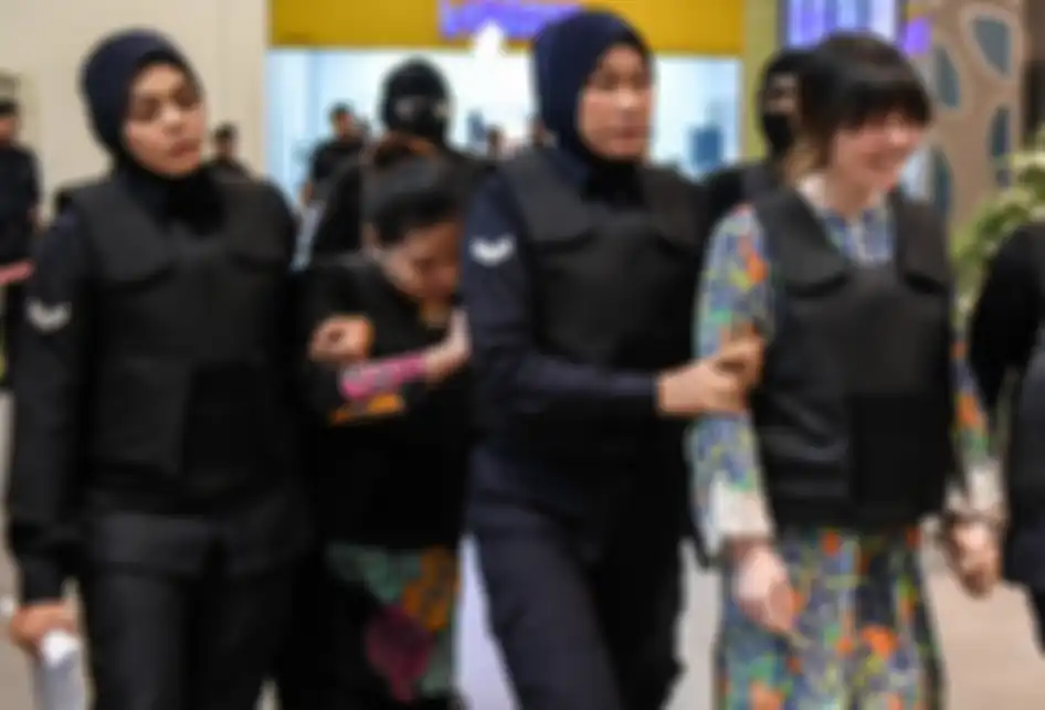 Terdakwa warga Vietnam, Doan Thi Huong (kanan) dan terdakwa warga Indonesia Siti Aisyah (kedua, kiri) dikawal petugas polisi di Bandara Internasional Kuala Lumpur 2 di Sepang, saat kunjungan ke lokasi pembunuhan sebagai bagian proses persidangan, pada 24 Oktober 2017. Siti Aisyah yang menjadi terdak