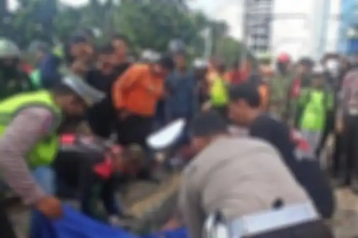 Polisi saat mengevaukasi korban driver ojol yang tewas tertabrak KRL.
