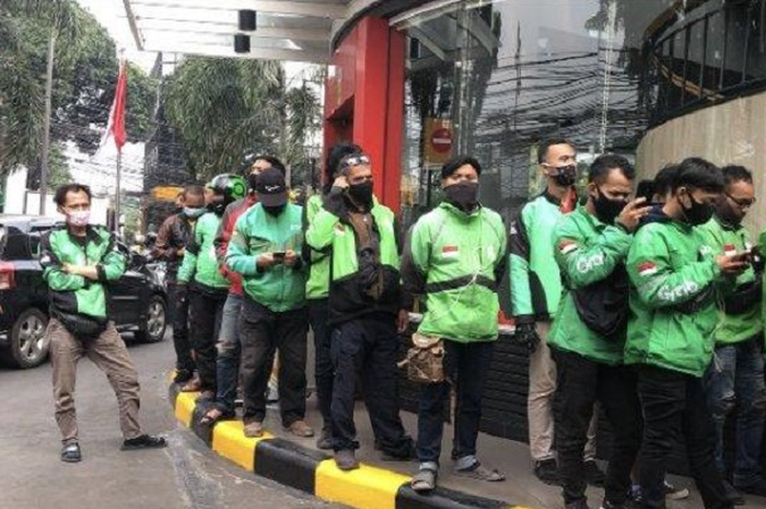 Ilustrasi setoran beban pajak driver ojol menjadi sorotan.
