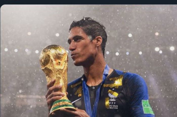 Raphael Varane mencium trofi Piala Dunia 2018 setelah juara bersama timnas Prancis.