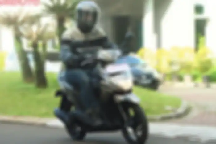Ilustrasi mengendarai motor matik