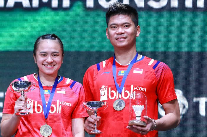 Pasangan ganda campuran Indonesia, Praveen Jordan (kanan)/Melati Daeva Oktavianti, berpose di atas podium kampiun All England Open 2020, di Arena Birmingham, Inggris, Minggu (15/3/2020).