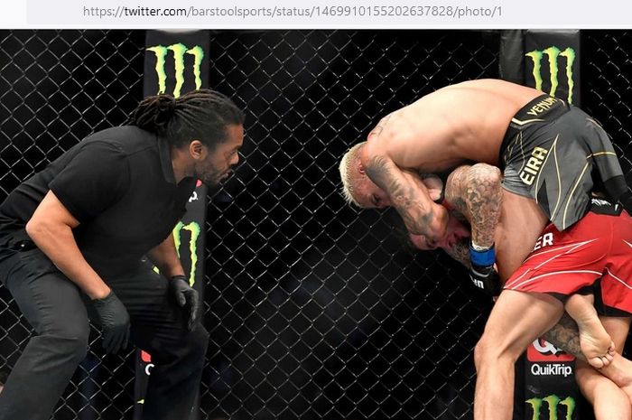 Juara kelas ringan, Charles Oliveira (celana hitam), melakukan rear-naked choke kepada Dustin Poirier pada UFC 269 di T-Mobile Arena, Nevada, Amerika Serikat, 11 Desember 2021.