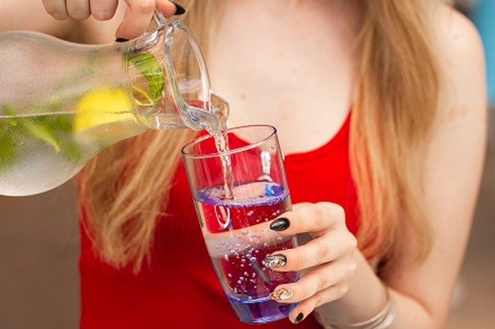Ilustrasi perempuan minum air lemon