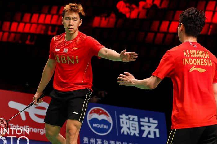 Pasangan ganda putra Indonesia, Marcus Fernaldi Gideon/Kevin Sanjaya Sukamuljo, melakukan tos di sela pertandingan melawan wakil Thailand, Supak Jomkoh/Kittinupong Kedren, pada lanjutan penyisihan Grup A Thomas Cup 2020 di Ceres Arena, Aarhus, Denmark, Senin (11/10/2021).