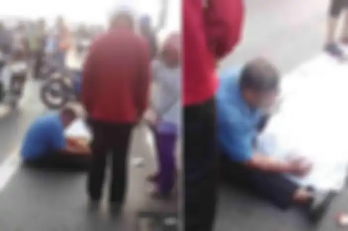Seorang bapak memeluk erat istrinya yang meninggal usai kecelakaan.