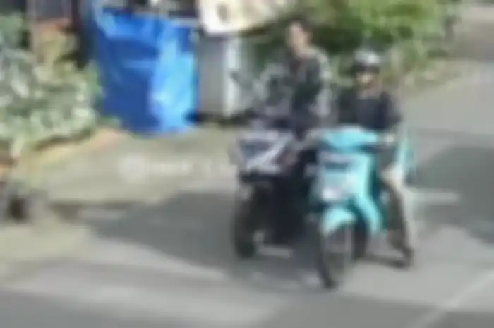 Pemotor Honda Vario tampak membantu menuntun motor mogok milik orang tak dikenal.