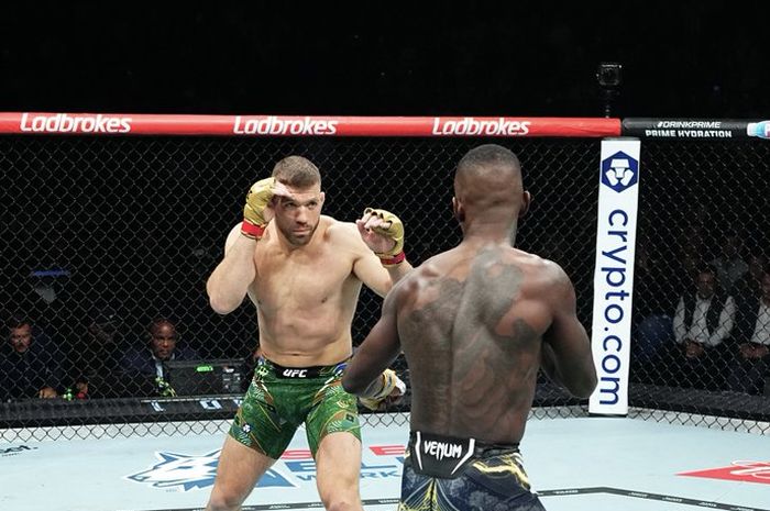 Petarung Selandia Baru, Israel Adesanya membelakangi kamera saat menghadapi Dricus Du Plesis (Afrika Selatan) pada perebutan gelar kelas menengan UFC 305 di Rach Arena, Perth, Australia, Minggu (18/8/2024) WIB.