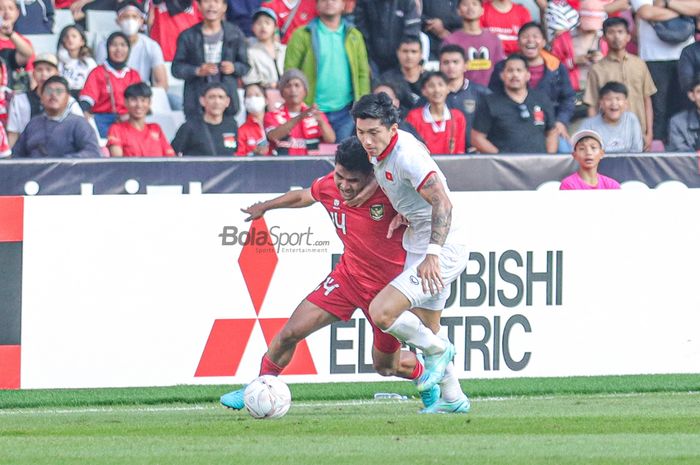 Bek sayap kanan Timnas Indonesia, Asnawi Mangkualam Bahar (kiri), berebut bola dengan pemain ganas Vietnam Doan Van Hau dalam leg pertama semifinal Piala AFF 2022 di Stadion Utama Gelora Bung Karno, Senayan, Jakarta, 6 Desember 2023.