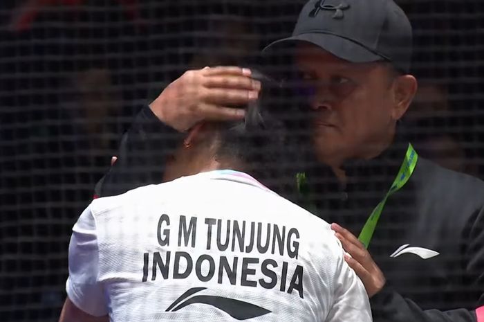 Tunggal putri Indonesia, Gregoria Mariska Tunjung, menangis di bahu sang pelatih Herli Djaenudin setelah kalah menyesakkan akibat insiden flash di perempat final All England Open 2024 di Utilita Arena Birmingham, Inggris, Jumat (15/3/2024).