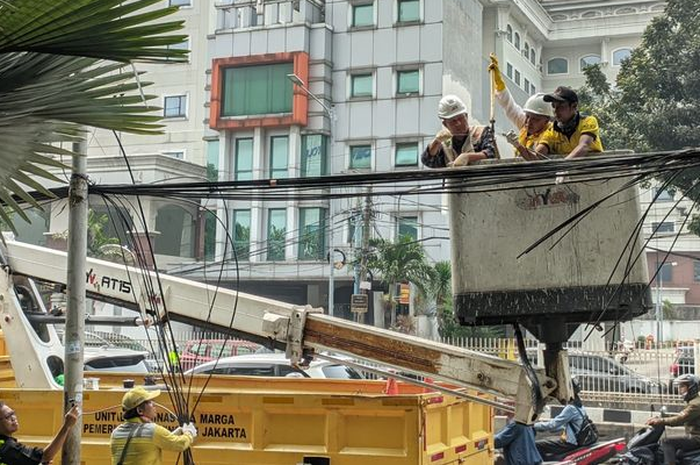 Ilustrasi. Semrawutnya kabel internet di Jakarta bisa jadi musibah untuk pengendara motor yang lewat.