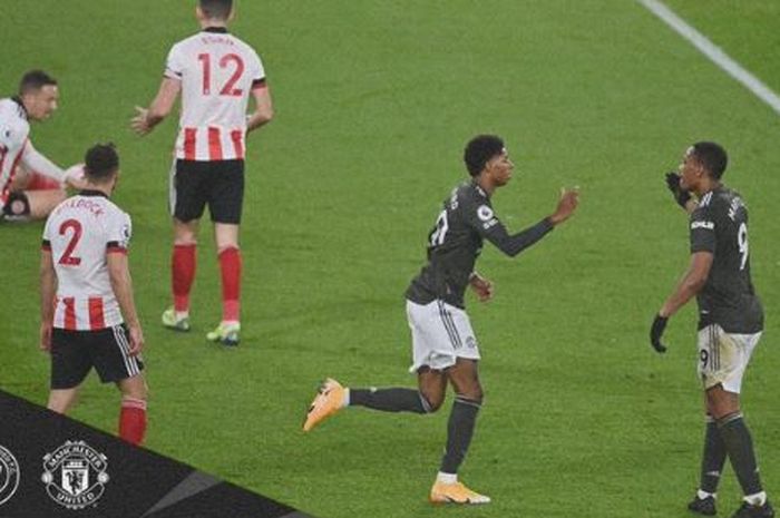 Striker Manchester United, Marcus Rashford, melakukan selebrasi bersama Anthony Martial seusai membobol Sheffield United dalam laga Liga Inggris di Stadion Bramall Lane, Kamis (17/12/2020).