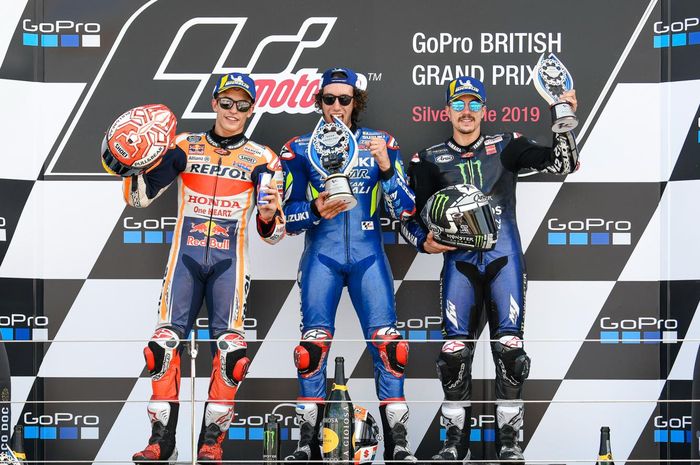 Dari kiri ke kanan, Marc Marquez, Alex Rins, dan Maverick Vinales berpose di podium MotoGP Inggris di Sirkuit Silverstone, Minggu (25/8/2019).