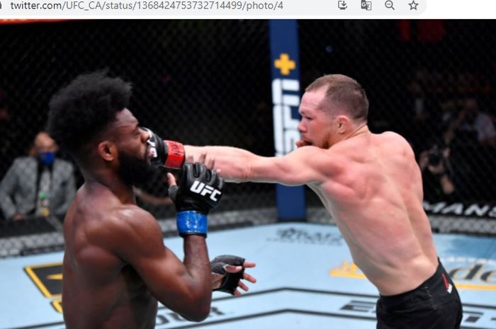 Petr Yan (kanan) saat mendaratkan pukulan tepat mengenai wajah Aljamain Sterling (kiri) saat bentrok pada ajang UFC 259, Minggu (7/3/2021).