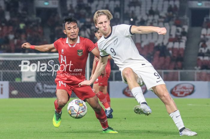 Striker timnas U-20 Selandia Baru, Kian Donkers (kanan), sedang mengoper bola dan dibayangi pemain timnas U-20 Indonesia bernama Robi Darwis (kiri) dalam laga turnamen Mini Internasional di Stadion Gelora Bung Karno, Senayan, Jakarta, Minggu (19/2/2023) malam.