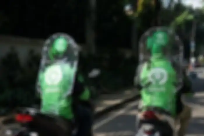 Ilustrasi mitra driver Gojek mengendarai sepeda motor.(Dok. Gojek)