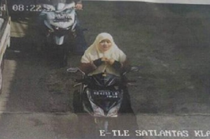 Emak-emak tanpa helm terkena tilang elektronik.