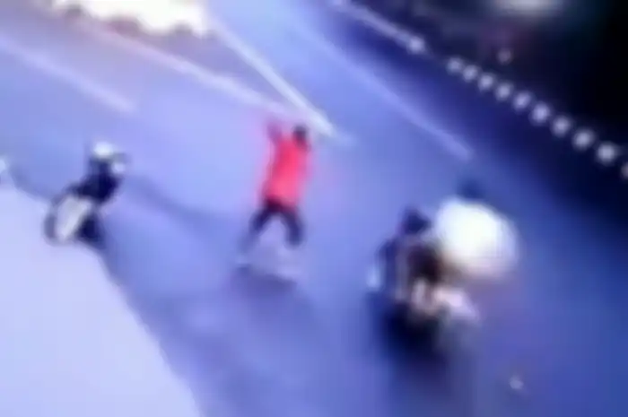 Preman kampung membahayakan pemotor dengan menyabetkan parang.