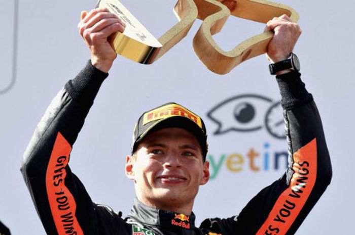 Pebalap Red Bull Racing, Max Verstappen, mengangkat trofi yang diraihnya seusai memenangi balapan GP