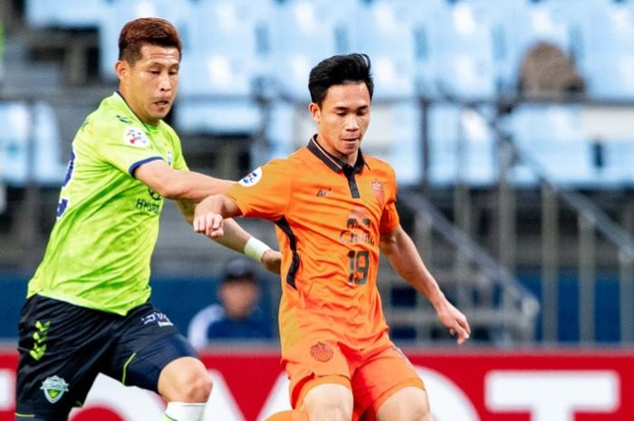 Penyerang Buriram United, Supachok Sarachart (kanan) saat coba dihentikan pemain Jeonbuk FC pada laga pamungkas fase grup Liga Champions Asia 2019 di Jeonju World Cup Stadium, 21 Mei 2019. 