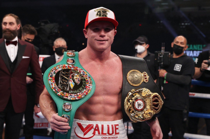 Petinju kelas menengah super, Canelo Alvarez, saat memamerkan sabuk juara WBA dan WBC.